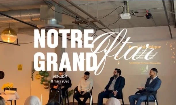Panel discussion at Notre Affaire event with five speakers seated in chairs on stage under industrial ceiling